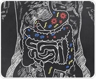 Social living allows genetic effects to spread through the gut microbiome